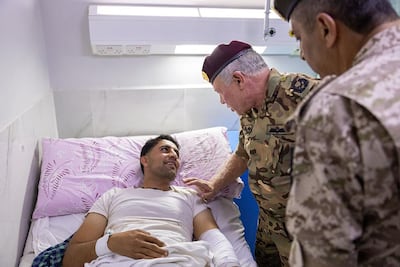 Jordan's King Abdullah II visits the injured at Prince Ali Military Hospital, in Karak governorate. AFP