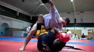 Fernando Cosendey, in light grey, fights with a sparring partner during practice.