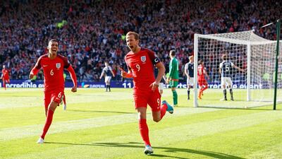Harry Kane, right, saved England with a stoppage time goal to end things level against Scotland at 2-2 in Hampden Park in Glasgow yesterday. Robert Perry / EPA
