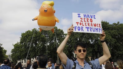 Protesters gather around the giant balloon. AFP