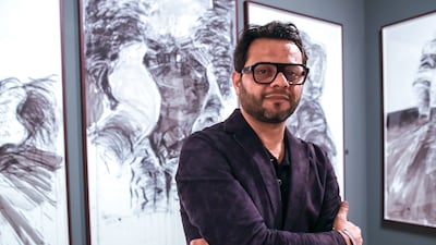 Harb at the opening of his exhibition. Victor Besa / The National