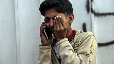 A relative of a victim of a bus accident talks on a mobile phone as he visits a mortuary to receive the body, in Karachi. At least 57 people were killed in a collision between a bus and oil tanker in southern Pakistan, according to officials. The accident happened on the Karachi to Shikarpur highway in Sindh province. Shahzaib Akber / EPA