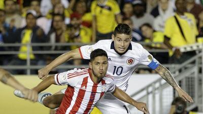 Colombia’s James Rodriguez, top, shoots under pressure by Paraguay’s Bruno Valdez during the second half of a Copa America Centenario Group A match at the Rose Bowl, Tuesday, June 7, 2016, in Pasadena, California. Jae C Hong/AP Photo