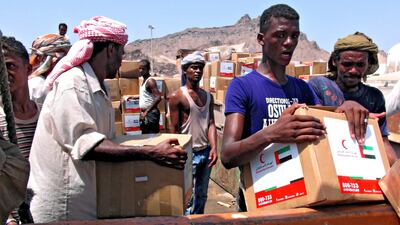 Yemenis unload an aid shipment provided by the Emirates Red Crescent at the port city of Aden. The charity group sent more than 830 tonnes of aid. A number of flights to the country containing medical and food aid were also organised by the Khalifa Foundation. EPA