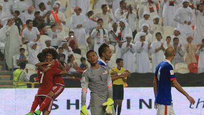 UAE players Ali Mabkhout and Omar Abdulrahman, left, celebrate during the UAE's 10-0 victory over Malaysia. Ravindranath K / The National