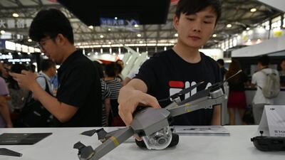 A man checks a DJI drone during the Consumer Electronics Show, Ces Asia 2019 in Shanghai. AFP