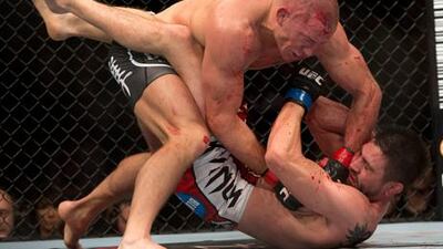 UFC welterweight champion Georges St. Pierre lands a blow to interim champion Carlos Condit in their unification bout.