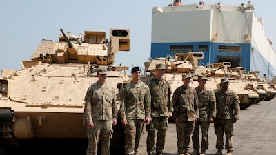 American soldiers stand near armoured fighting vehicles given to the Lebanese army by the US government, at Beirut's port on August 14, 2017. Mohamed Azakir / Reuters