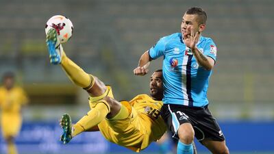 Al Wasl's Hamad Al Hosani, left, tries to gain possession during their match against Baniyas on Friday. The game ended in a 1-1 draw. Al Ittihad