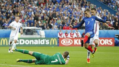Antoine Griezmann chips Iceland goalkeeper Hannes Halldorsson to score France’s fourth goal. John Sibley / Reuters