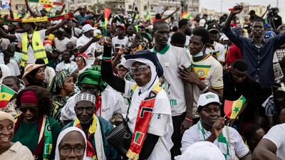 TOPSHOT - A supporter of Senegal’s Prime Minister Ousmane Sonko dances during a rally in Dakar, on November 8, 2025. (Photo by PATRICK MEINHARDT / AFP)