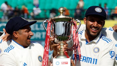 Sarfaraz Khan, left, and Dhruv Jurel lift the Test series trophy after India defeated England 4-1 in Dharamsala. Reuters