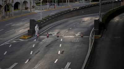 A security guard regulates traffic at an exit of a tunnel that leads to the Pudong area, across the Huangpu river, in Shanghai. Reuters