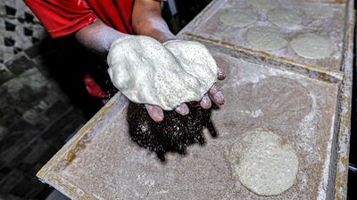 A worker prepares flatbread at a bakery in Cairo. Egypt is facing an acute shortage of wheat, with a little more than two months of stocks. AFP