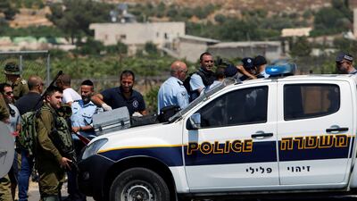 Israeli forces gather at the scene where a Palestinian man was shot dead following an alleged car-ramming attack at the entrance of Beit Einun village, near the West Bank city of Hebron, on July 18, 2017. Mussa Qawasma / Reuters