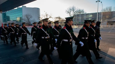 Paramilitary police officers march outside Beijing Railway Station. AFP