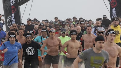 About 5,000 people trudged through mud, sand and various obstacles in the UAE's first Spartan Race. Antonie Robertson / The National
