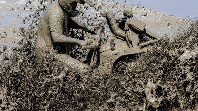 A quad biker tackles a mud pool at the International Off Road Festival in Somogybabod, Hungary. EPA