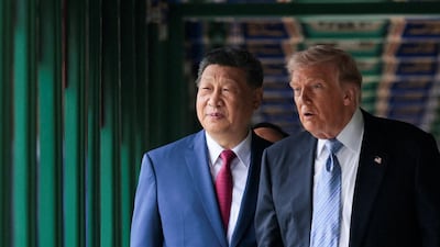 Mr Trump and Mr Xi walk through Zhongnanhai Garden. Reuters