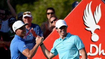 Rory McIlroy celebrates his 'hole-in-one' with Rickie Fowler on the par three 15th hole during the second round of the Abu Dhabi HSBC Golf Championship on January 16. Ross Kinnaird/Getty