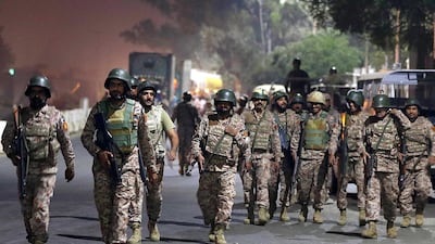 Paramilitary soldiers walk near supporters of religous group Tehrik Labaik Ya RasoolAllah (TLP) during a protest over the Khadim Hussain Rizvi arrest in Karachi, Pakistan. Tehreek-e-Labbaik Pakistan (TLP) chief Khadim Hussain Rizvi has been taken into protective custody by the police. EPA