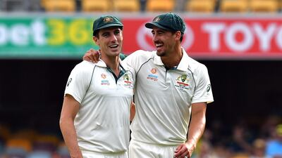 Australia's paceman Mitchell Starc (R) and Pat Cummins celebrate their victory in the first Test. AFP