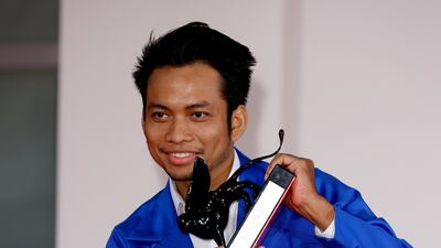 Director Neang Kavich poses, on behalf of Piseth Chhun, with the Best Actor Orizzonti Award for 'White Building'. Getty Images
