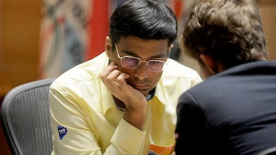 India's Vishwanath Anand (L) ponders before a making a move against Norway's Magnus Carlsen during the 10th championship chess match with in Chennai on November 22, 2013. Norwegian prodigy Magnus Carlsen began his 10th match with India's Viswanathan Anand needing just a draw to take the world champion crown and complete his ascent to the top of the game. AFP PHOTO/Manjunath KIRAN