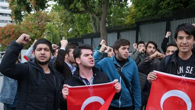 Members of the Youth Union of Turkey (TGB) wave flags as they protest in front of the US embassy in Ankara after US President made threats against Turkey. AFP