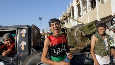 A Libyan rebel fighter reacts inside the main Moammar Gadhafi compound in Bab al-Aziziya in Tripoli, LIbya, Tuesday, Aug. 23, 2011. Libyan rebels stormed Moammar Gadhafi's main military compound in Tripoli Tuesday after fierce fighting with forces loyal t???