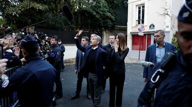 Former French president Nicolas Sarkozy waves to supporters as he leaves his house with his wife Carla Bruni-Sarkozy to begin his five-year prison sentence. Reuters