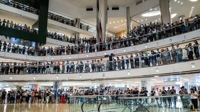 Residents and protesters sing songs and shout slogans as they gather at a shopping mall after business hours in Tai Koo district in Hong Kong, China. Getty