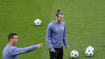 Real Madrid’s Gareth Bale, right, and Cristiano Ronaldo attend training. Francisco Seco / AP Photo