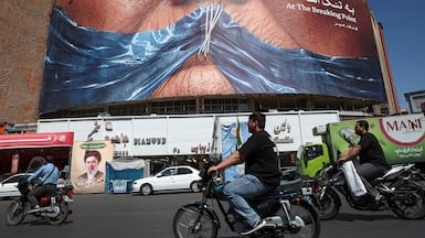 People ride past an anti-U. S. billboard depicting U. S. President Donald Trump and the Strait of Hormuz, in Tehran, Iran, May 25, 2026. Majid Asgaripour / WANA (West Asia News Agency) via REUTERS ATTENTION EDITORS - THIS PICTURE WAS PROVIDED BY A THIRD PARTY