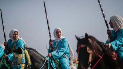 In this Thursday, July 25, 2019 photo, a female troupe prepares to take part in Tabourida, a traditional horse riding show also known as Fantasia, in the coastal town of El Jadida, Morocco.