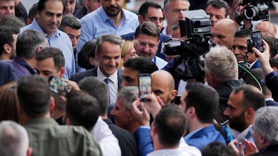Mr Mitsotakis, centre, arrives at his party's headquarters in Athens, on May 21. AP