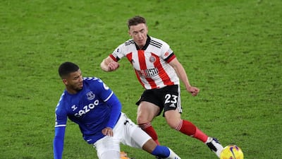 Ben Osborn of Sheffield United is tackled by Everton's Mason Holgate. Getty