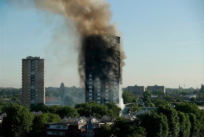 A grim spectacle as smoke rises from the charred shell of Grenfell Tower in London. AP