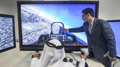 Shawn Racz, manager of Lockheed Martin’s Centre for Innovation and Security Solutions in Abu Dhabi, shows how the flight simulator and Prepar3D software provides realistic flight and emergency scenarios for trainees to hone their skills. Mona Al Marzooqi / The National