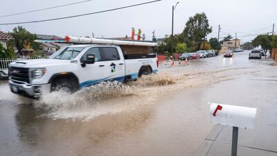 A pick-up truck is driven through a flooded junction in Salinas, California. AP