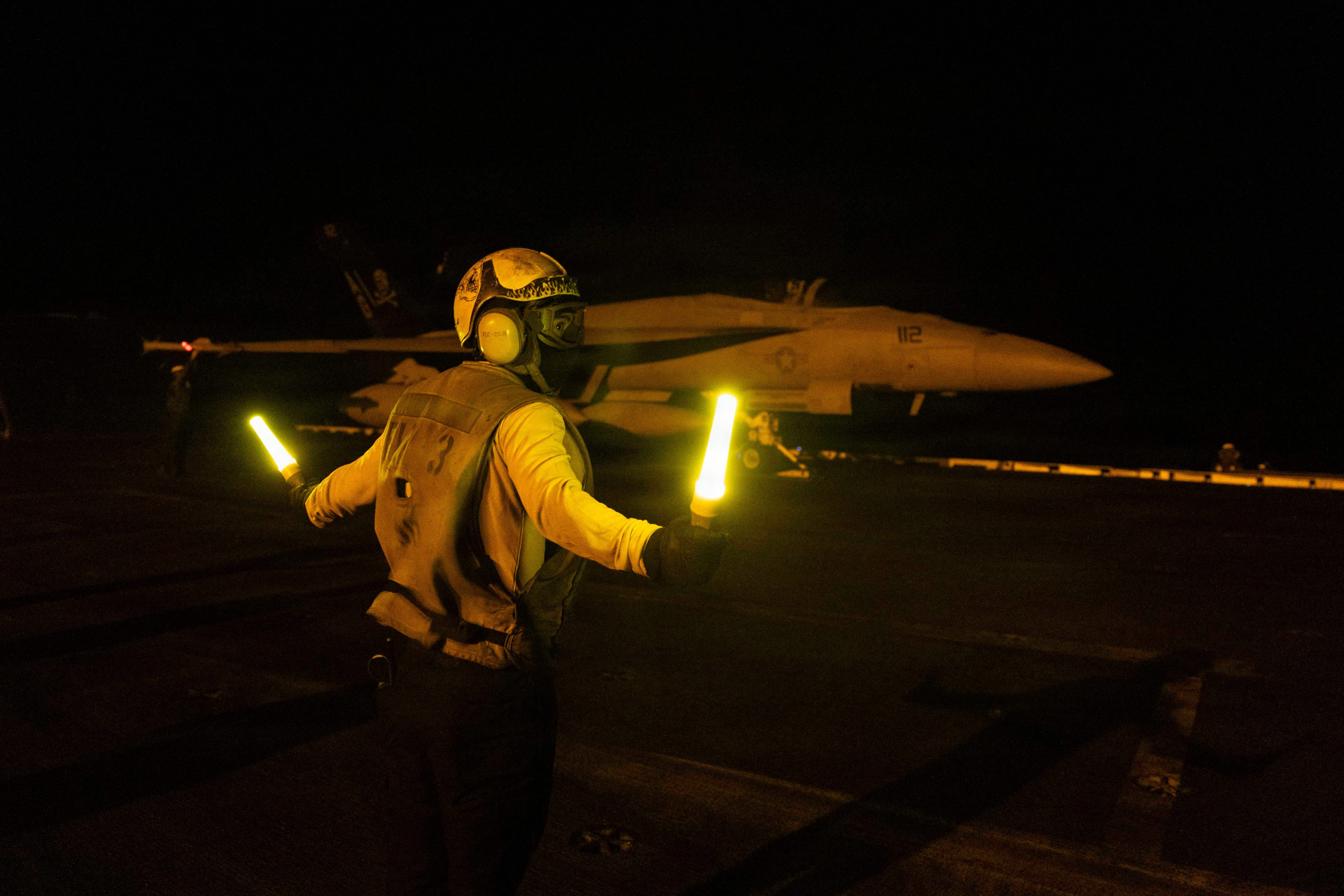 A US sailor signals an F/A-18E Super Hornet on the flight deck of Nimitz-class aircraft carrier USS George HW Bush in July. AFP