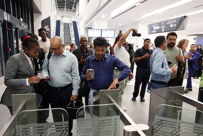 Passengers have their tickets at the ready for Dubai's first Etihad Rail train journey. Chris Whiteoak / The National