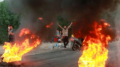 Anti-government protesters set fires and close a street during a demonstration in Baghdad, Iraq. AP Photo