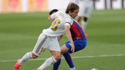 Real Madrid's Luka Modric goes past Eibar's Edu Expositio. AP