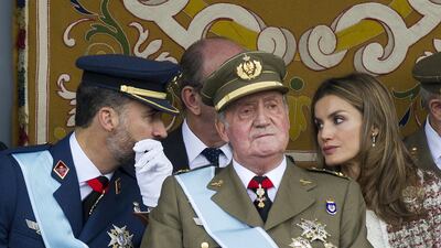 Spain’s King Juan Carlos, centre, is accompanied by Crown Prince Felipe, left, and Princess Letizia, right, during the Spanish National day military parade in Madrid on on October 12, 2012. The 76-year-old King Juan Carlos will abdicate in favour of his son, Prince Felipe, Prime Minister Mariano Rajoy announced on June 2, 2014. Dominique Faget/AFP Photo