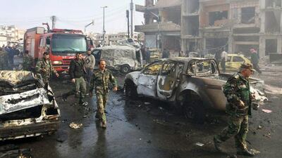 Syrians gather at the scene of ISIL bombings in the pro-government neighbourhood of Zahraa in Homs province on February 21, 2016. The extremist group is to be excluded from a Syria ceasefire scheduled to begin on February 28. Sana via AP