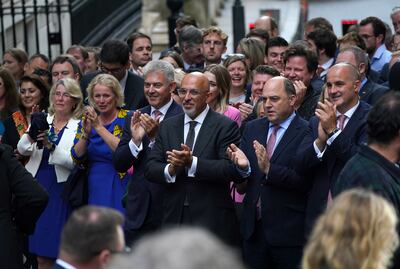 Secretary of State for Northern Ireland Brandon Lewis, centre left, Nadhim Zahawi, centre, and Defence Secretary Ben Wallace, centre right, clap after a speech by the new Prime Minister Liz Truss.