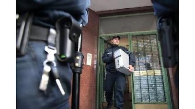 A police officer removes a computer from the Taiba mosque in Hamburg, Germany. The mosque gained notoriety as a meeting place for terrorists. AFP