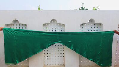 A nearly 100-year-old emerald-green satin salwar that is almost 2.5 metres long and requires two people to hold to be able to take the picture.