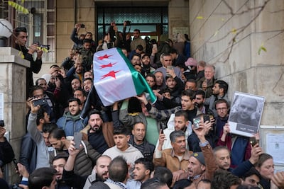 The coffin of Syrian activist Mazen Al Hamada is carried for burial in Damascus. AFP